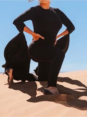 Black One-Piece Jumpsuit with Dramatic Long Cape Sleeves